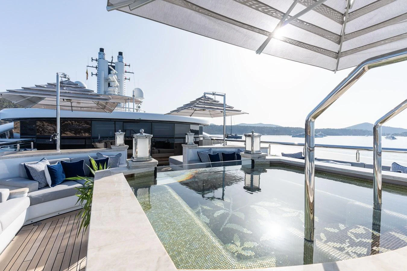 The sundeck features a luxurious pool surrounded by comfortable seating and shaded areas, perfect for relaxation. aboard I DYNASTY Yacht for Sale
