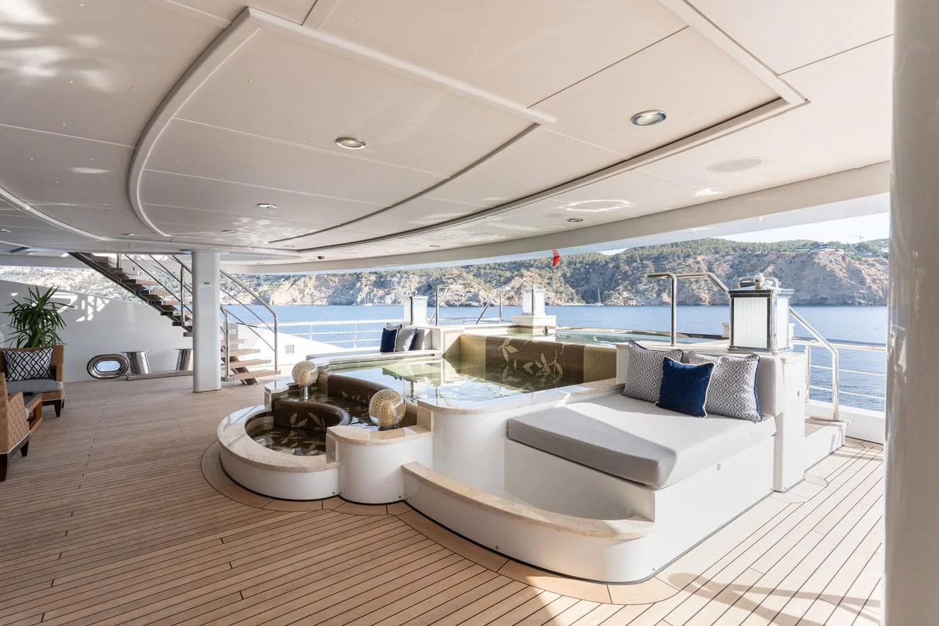 The aft deck features a luxurious lounging area with a jacuzzi and stunning sea views. aboard I DYNASTY Yacht for Sale