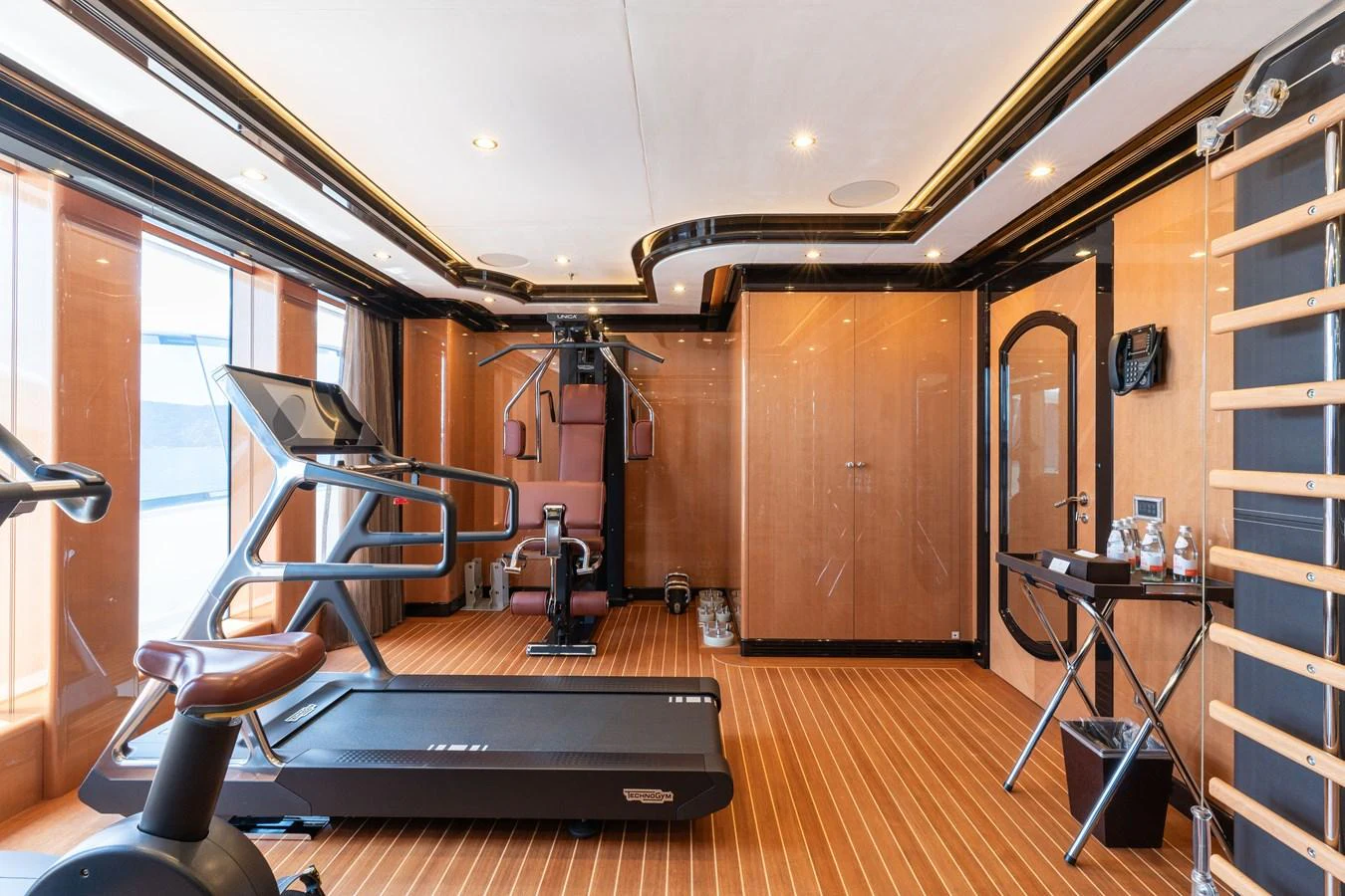 The yacht's gym is equipped with modern fitness machines and offers a spacious, well-lit environment for workouts. aboard I DYNASTY Yacht for Sale