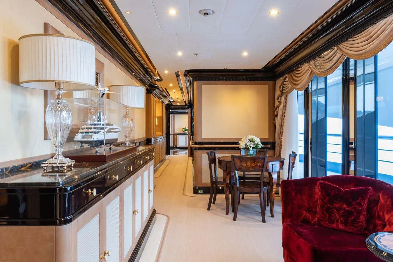 The yacht's interior features an elegant dining area with luxurious furnishings and decor. aboard I DYNASTY Yacht for Sale