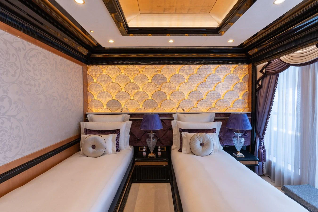 The guest stateroom features twin beds with elegant decor and soft lighting. aboard I DYNASTY Yacht for Sale