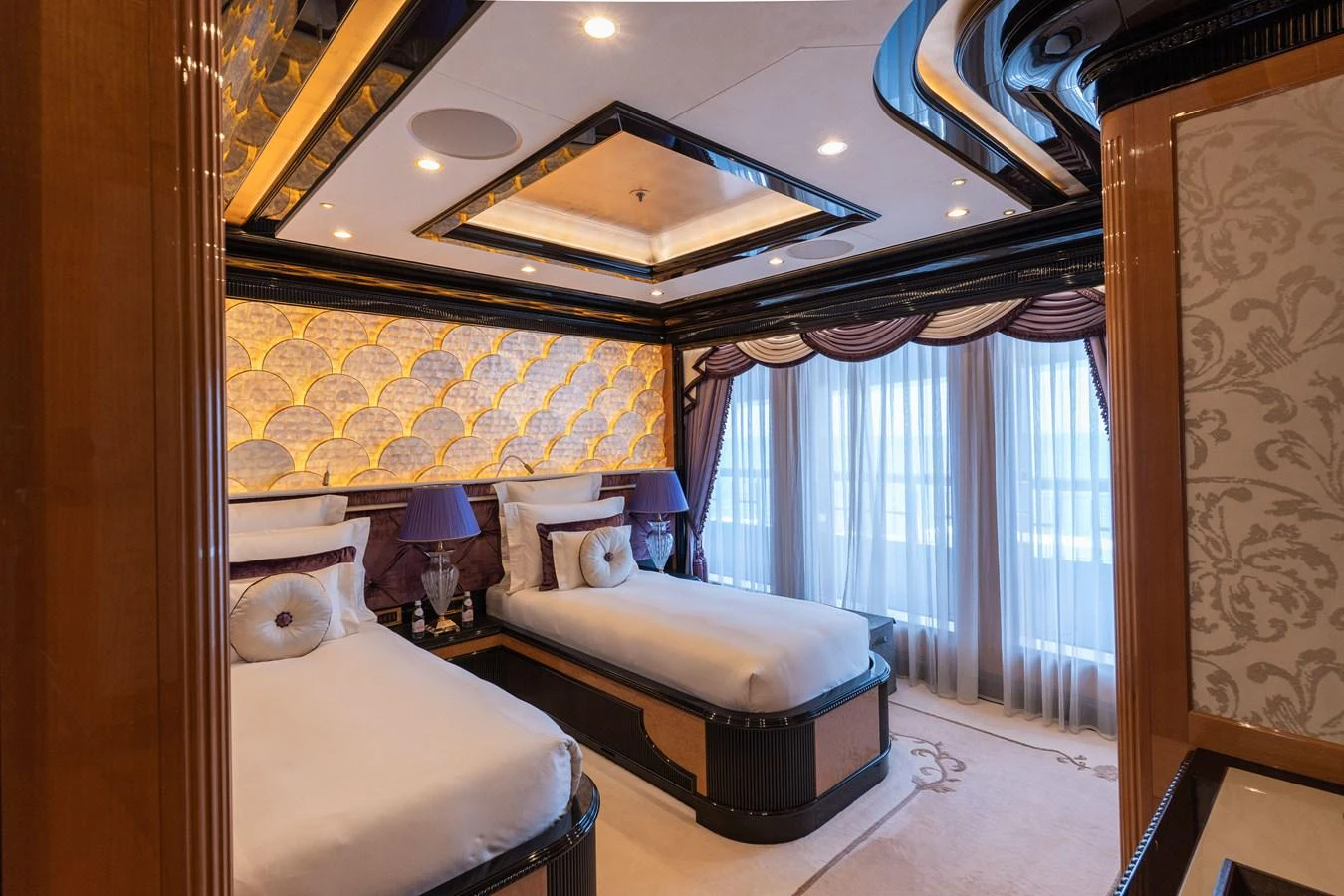 The guest stateroom features twin beds with luxurious decor and ample natural light. aboard I DYNASTY Yacht for Sale