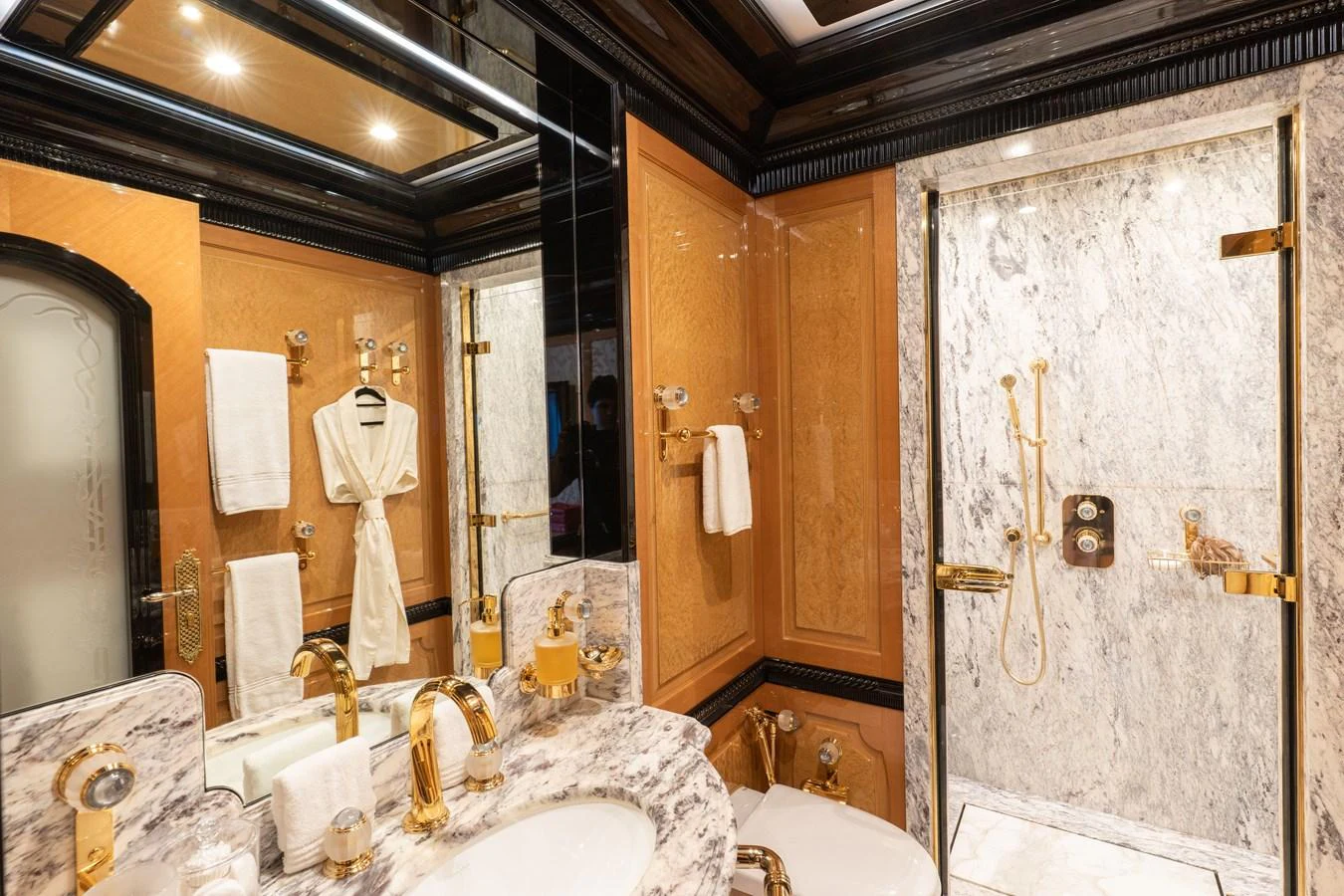 Luxurious bathroom with elegant marble finishes and gold accents. aboard I DYNASTY Yacht for Sale