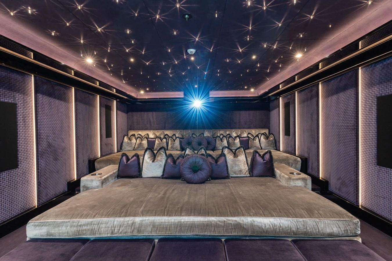 The yacht's theater room offers a luxurious and immersive cinematic experience with plush seating and ambient lighting. aboard I DYNASTY Yacht for Sale