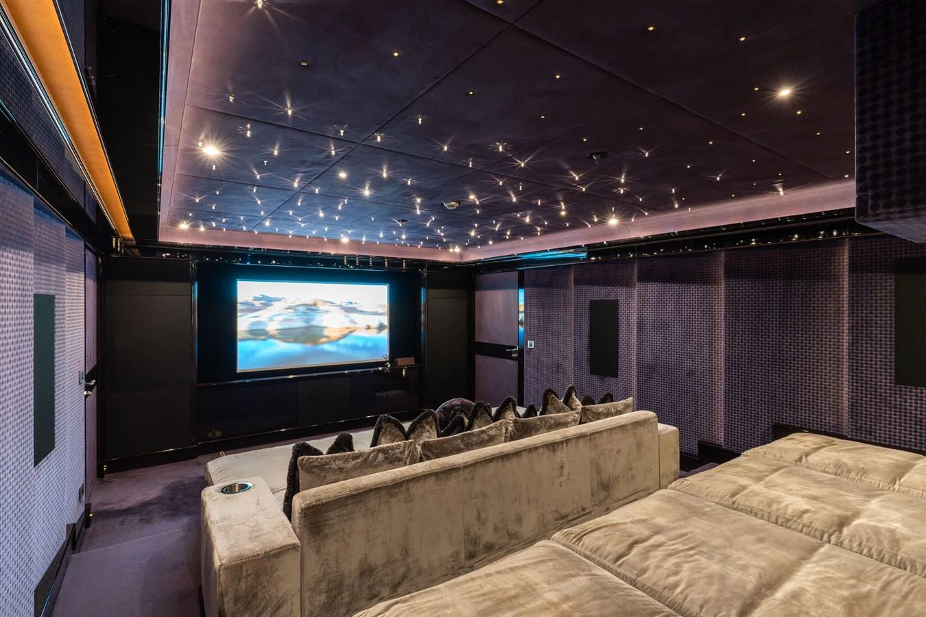 The yacht features a luxurious theater room with plush seating and a large screen for entertainment. aboard I DYNASTY Yacht for Sale
