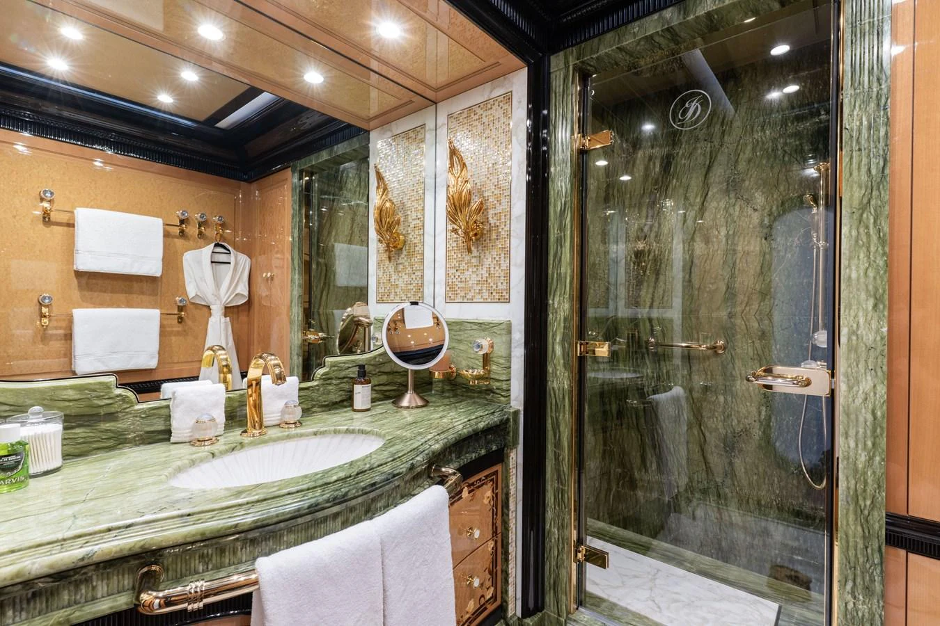 The yacht's bathroom features luxurious green marble and gold accents, creating an opulent atmosphere. aboard I DYNASTY Yacht for Sale
