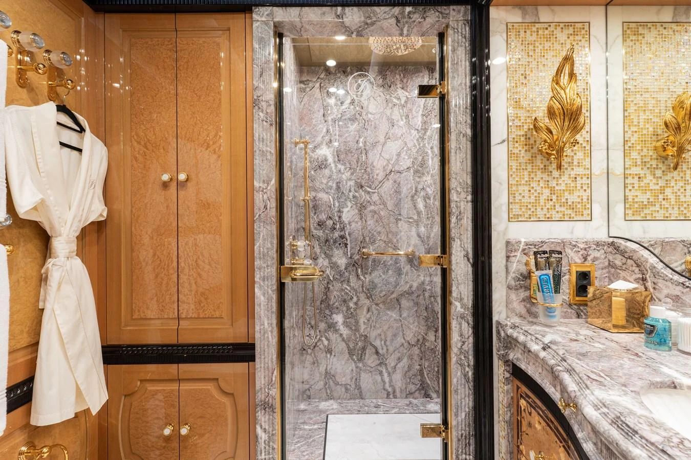 The luxurious bathroom features elegant marble surfaces and gold accents. aboard I DYNASTY Yacht for Sale