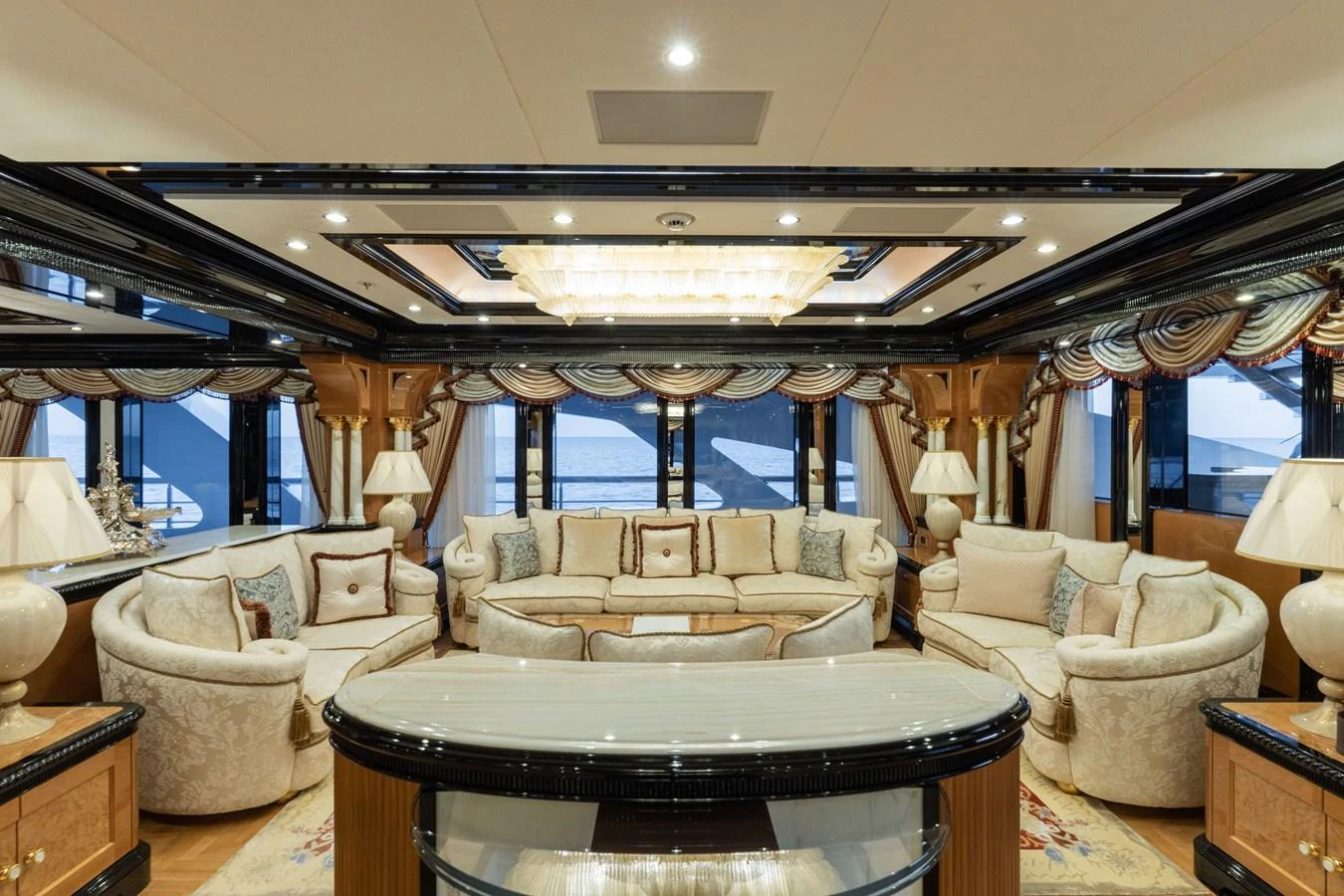 The salon features luxurious seating with elegant decor and expansive windows offering stunning views. aboard I DYNASTY Yacht for Sale