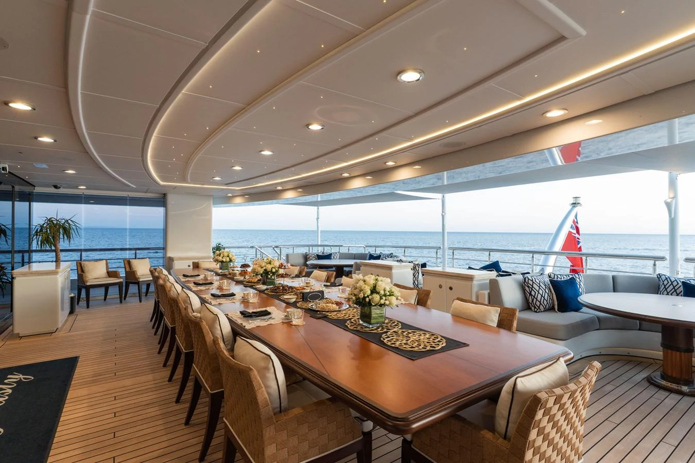 The yacht's dining area offers an elegant setting with a large table and comfortable seating, perfect for enjoying meals with a view of the sea. aboard I DYNASTY Yacht for Sale
