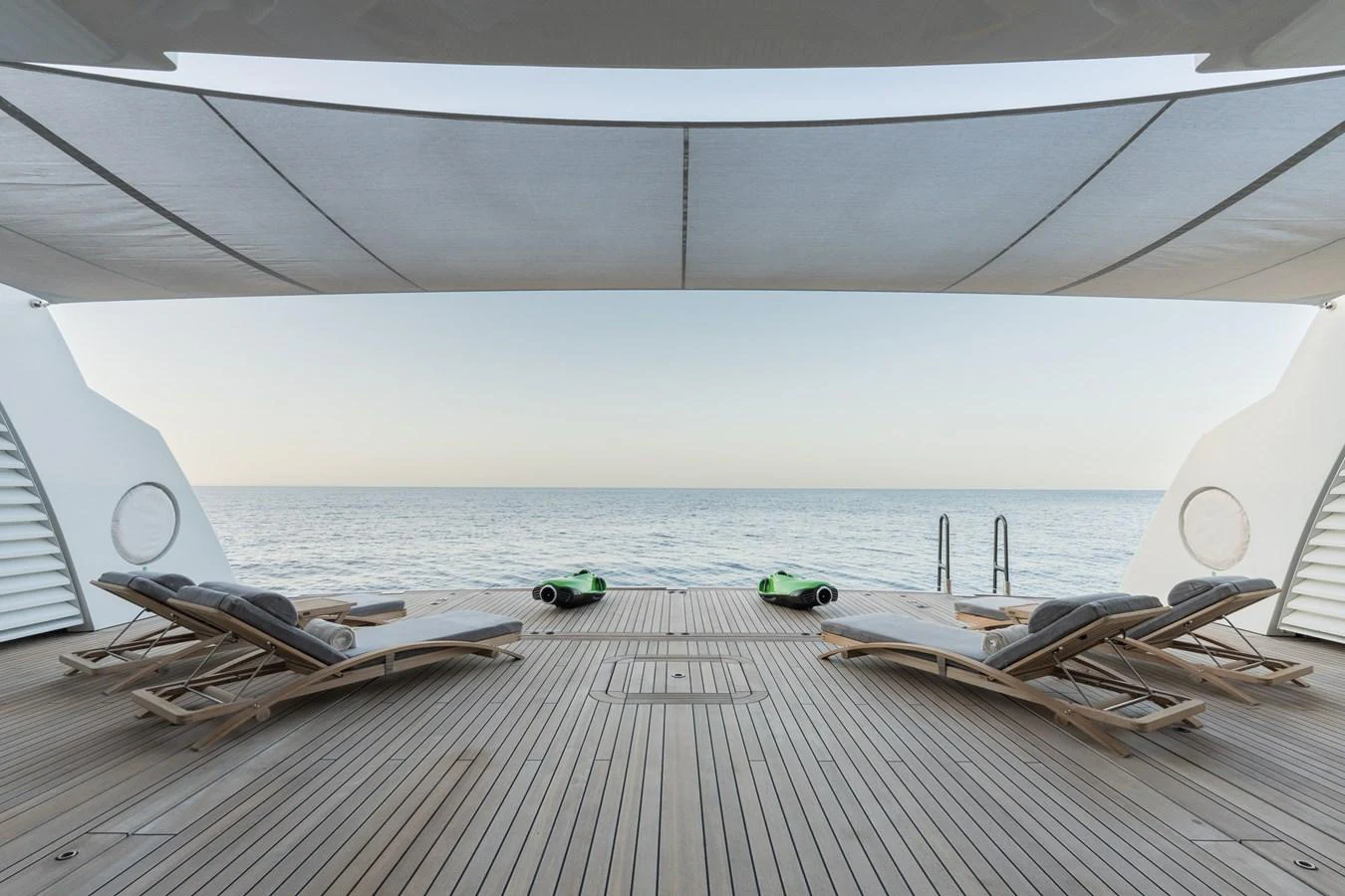The aft deck offers a serene lounging area with sunbeds and a view of the open sea. aboard I DYNASTY Yacht for Sale