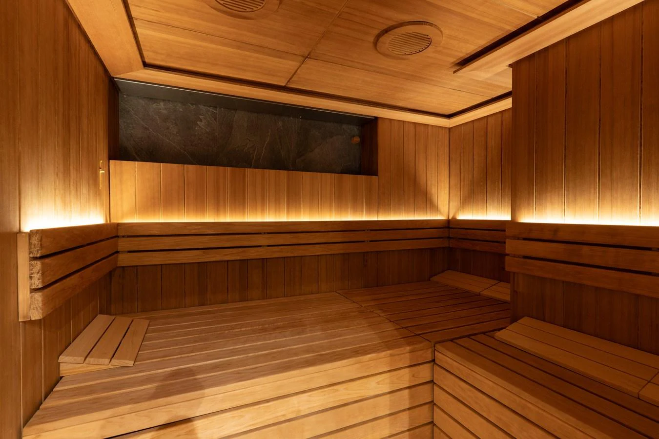 The yacht features a luxurious wooden sauna with ambient lighting. aboard I DYNASTY Yacht for Sale