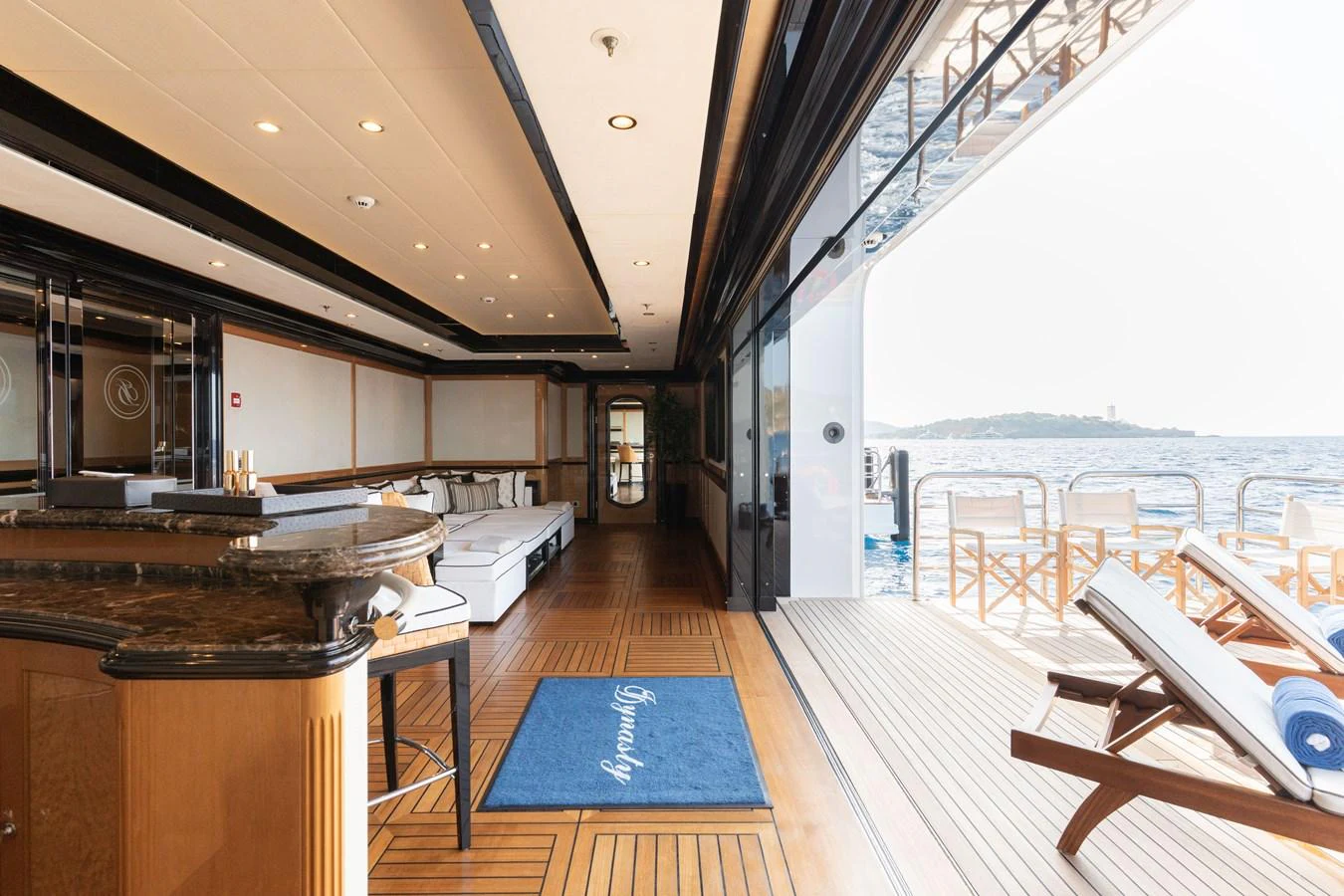 The aft deck offers a seamless transition from indoor to outdoor living with luxurious seating and ocean views. aboard I DYNASTY Yacht for Sale