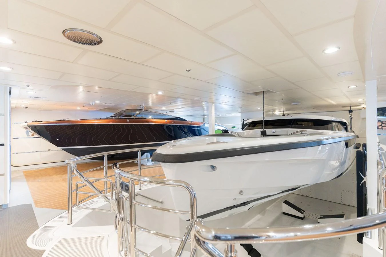 The yacht's tender garage showcases two sleek and well-maintained tenders ready for use. aboard I DYNASTY Yacht for Sale