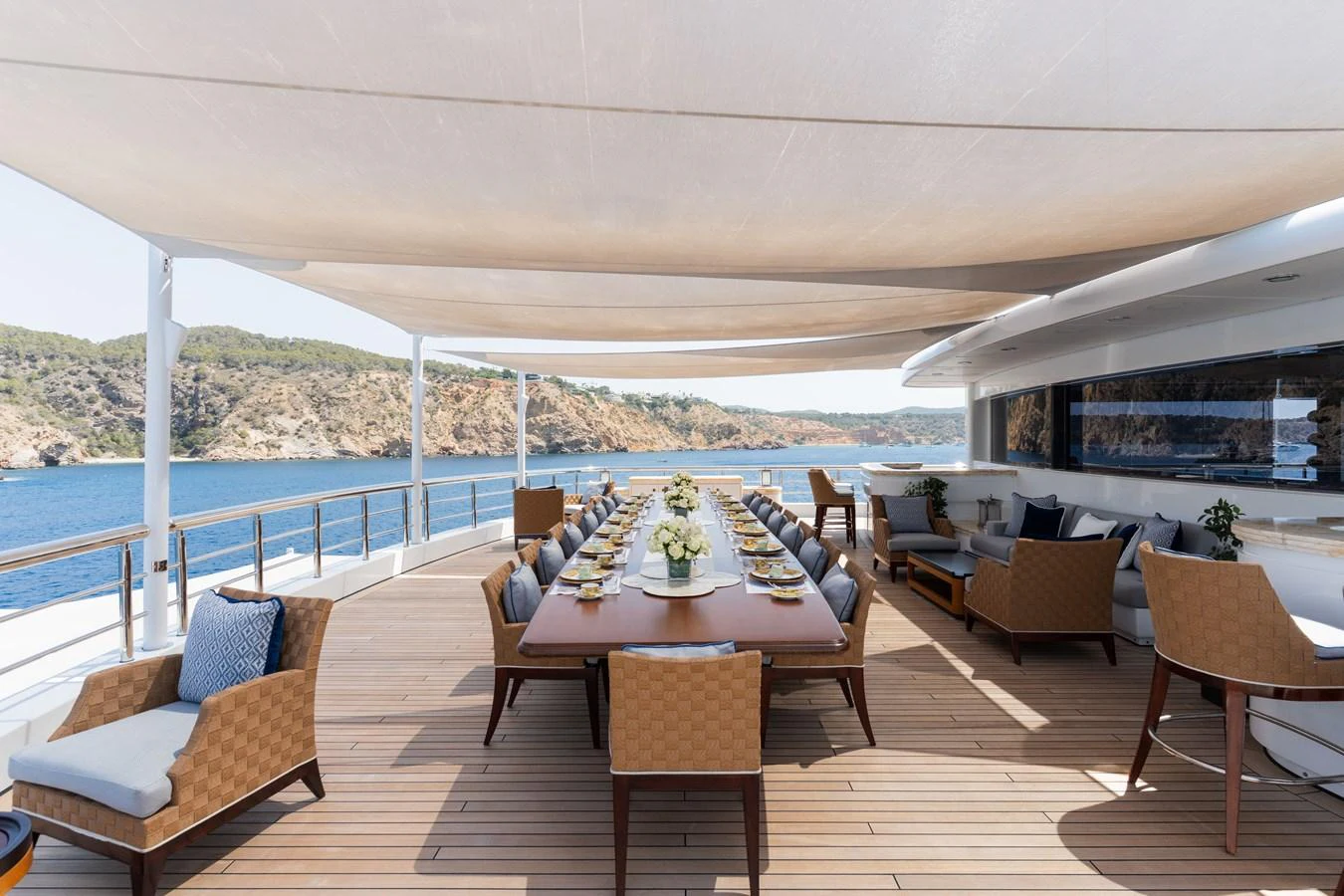 The aft deck features an elegant dining area with comfortable seating and stunning ocean views. aboard I DYNASTY Yacht for Sale