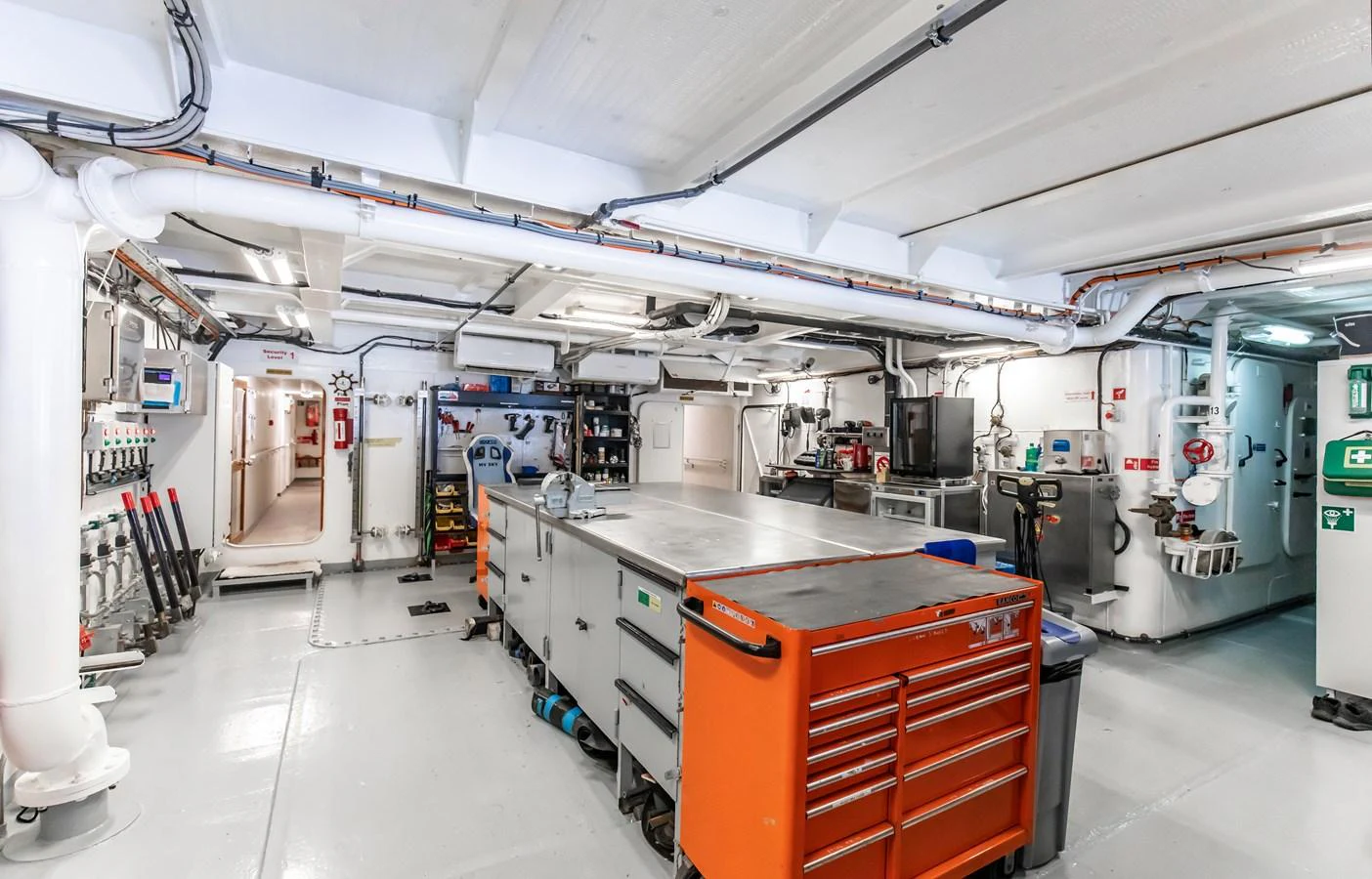 The engine room is equipped with various tools and machinery, showcasing a well-organized and functional space. aboard SKY Yacht for Sale