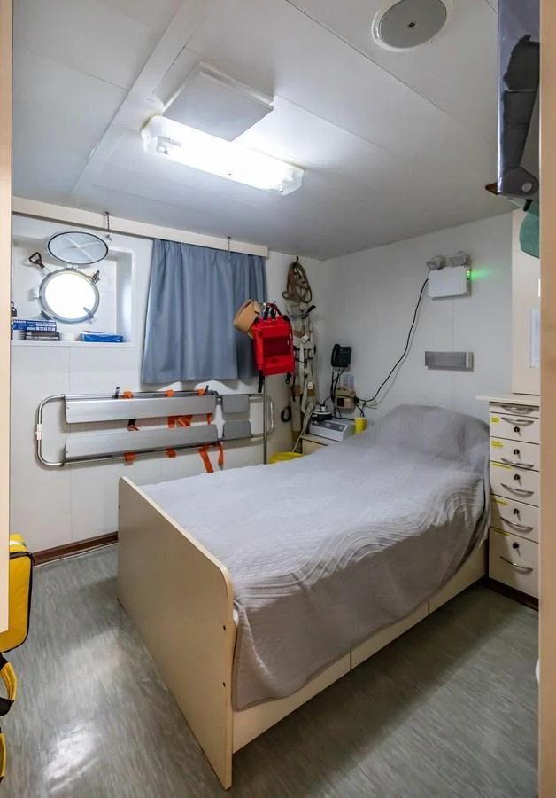 A functional crew cabin with a single bed and essential amenities. aboard SKY Yacht for Sale