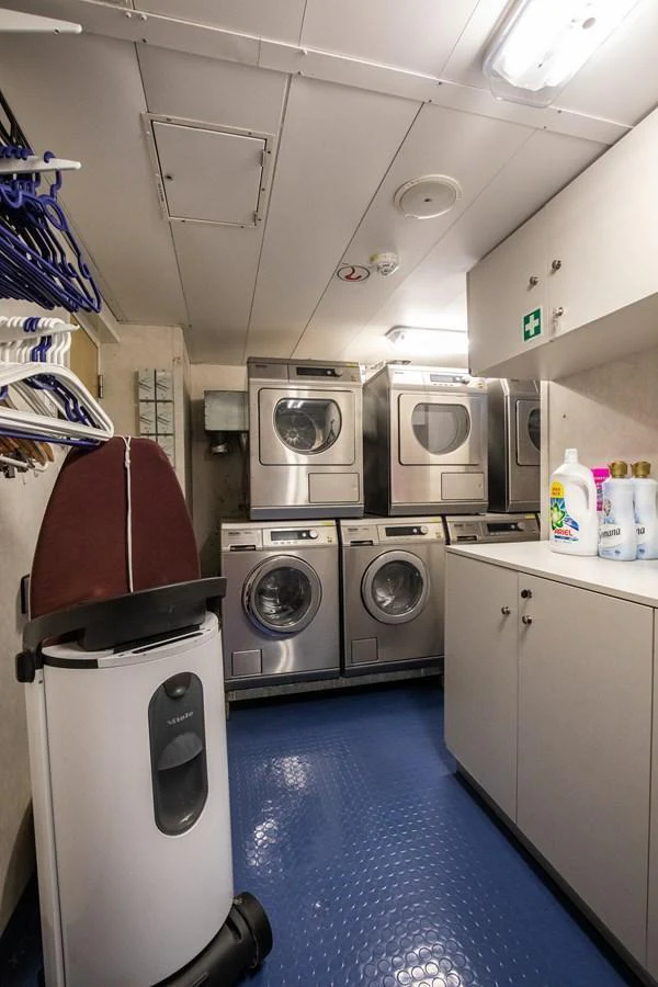 The yacht's laundry room is equipped with multiple washers and dryers for convenience. aboard SKY Yacht for Sale