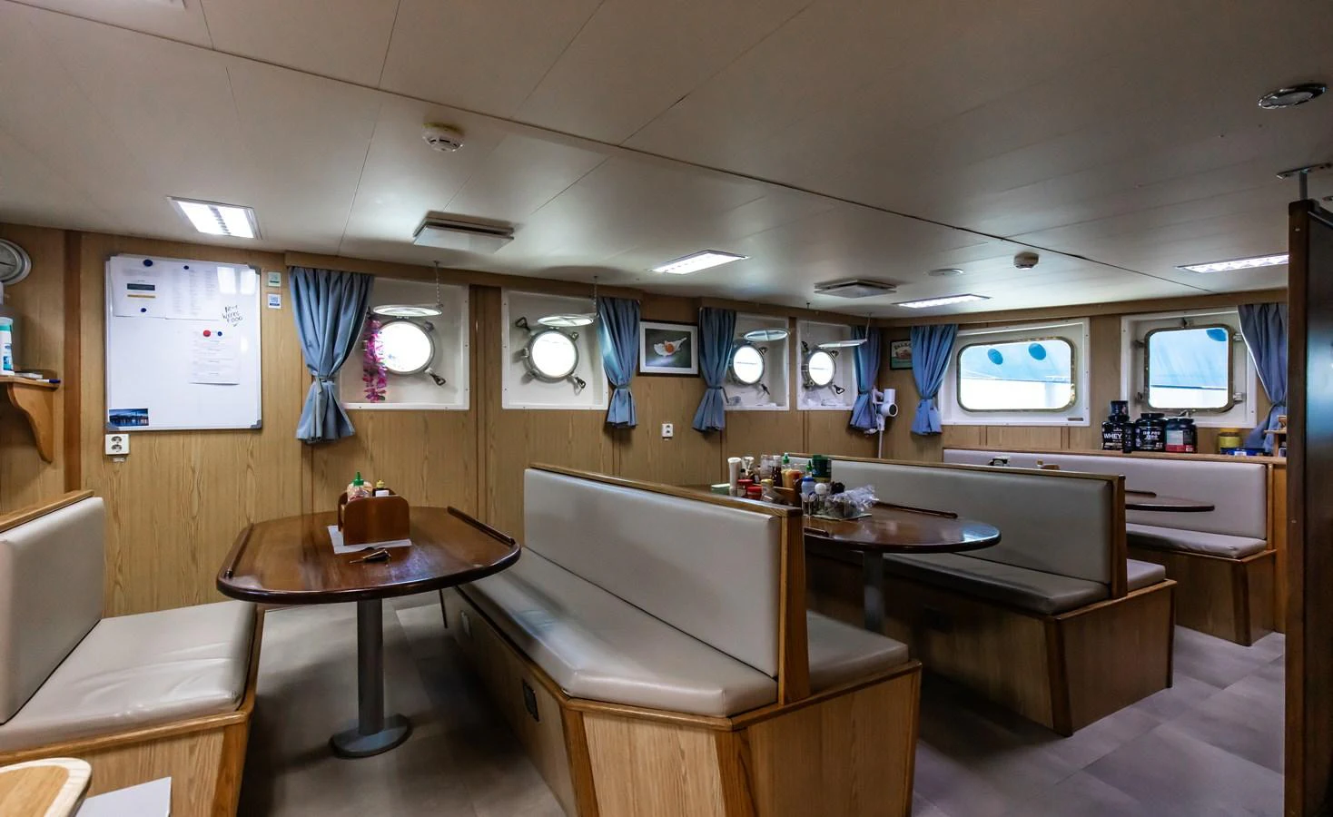 The yacht's dining area features comfortable booth seating and a cozy atmosphere. aboard SKY Yacht for Sale