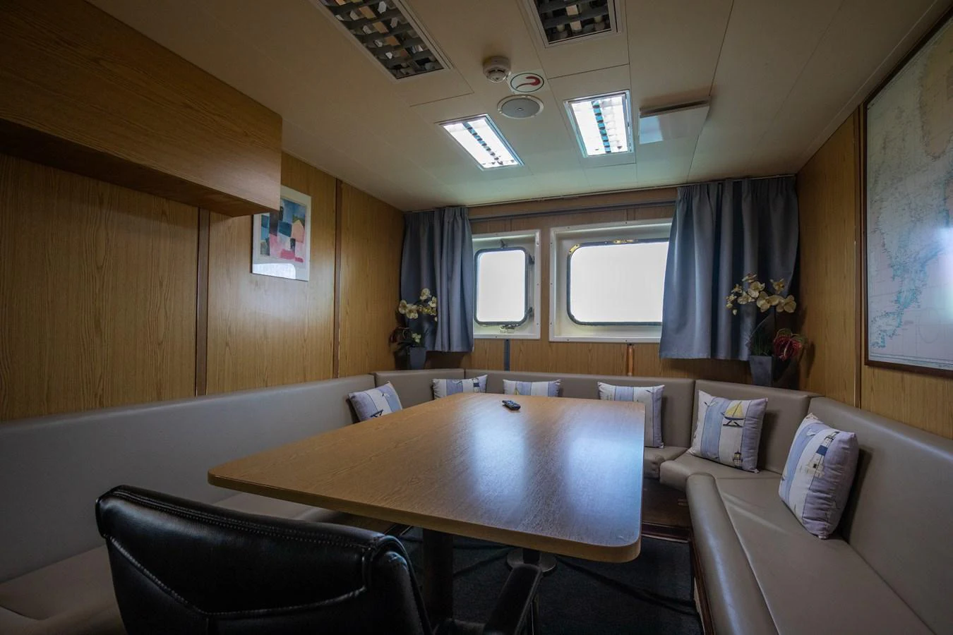 The cozy dining area features a large table surrounded by comfortable seating, perfect for intimate gatherings. aboard SKY Yacht for Sale