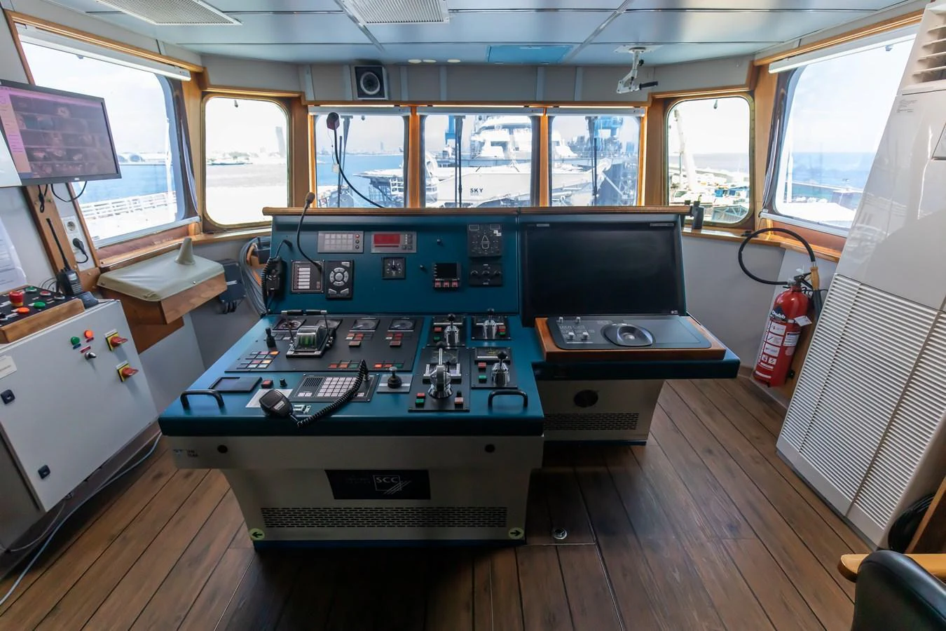 The helm station features advanced navigation and control equipment with panoramic views. aboard SKY Yacht for Sale