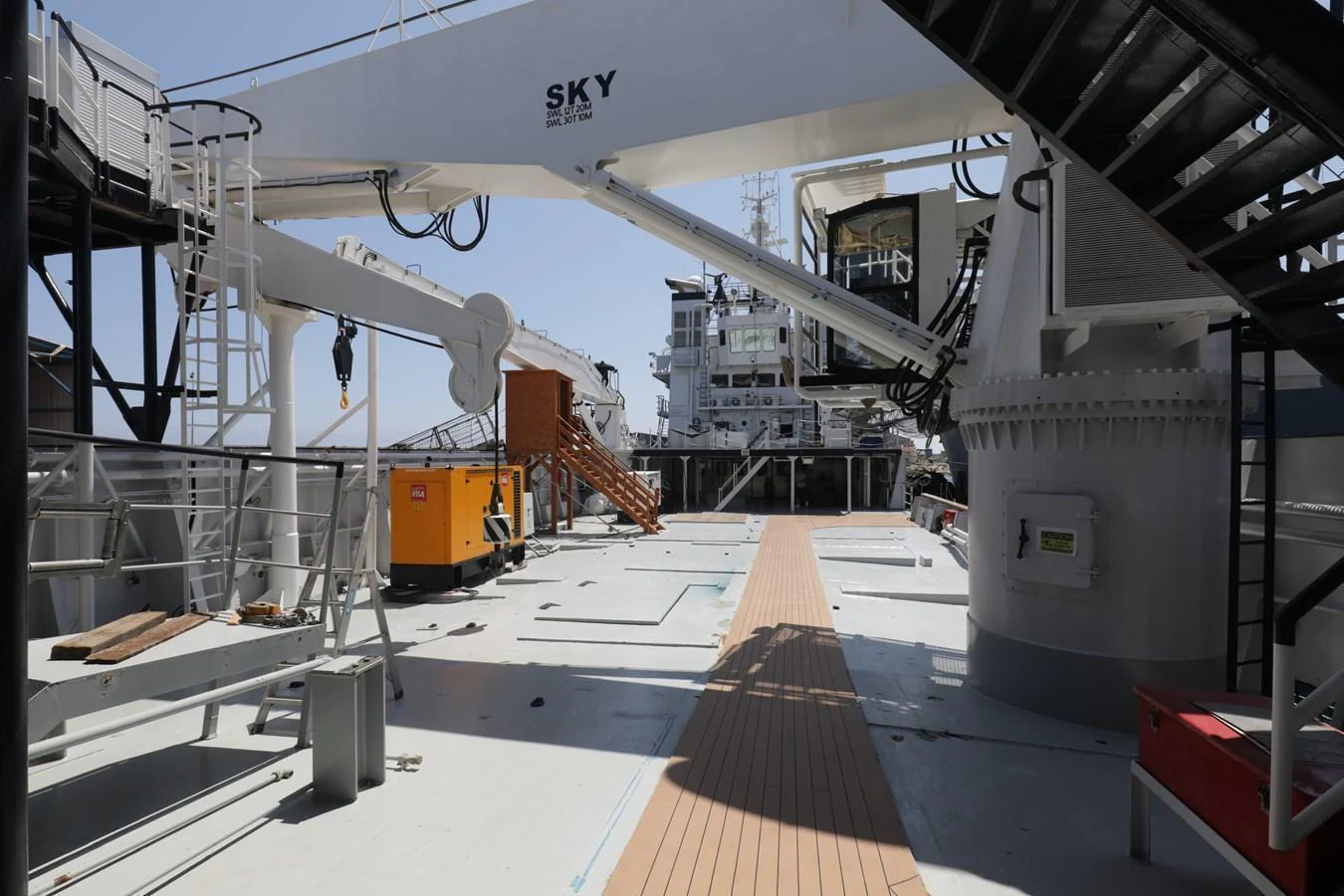 The yacht's exterior deck features industrial equipment and a spacious layout. aboard SKY Yacht for Sale
