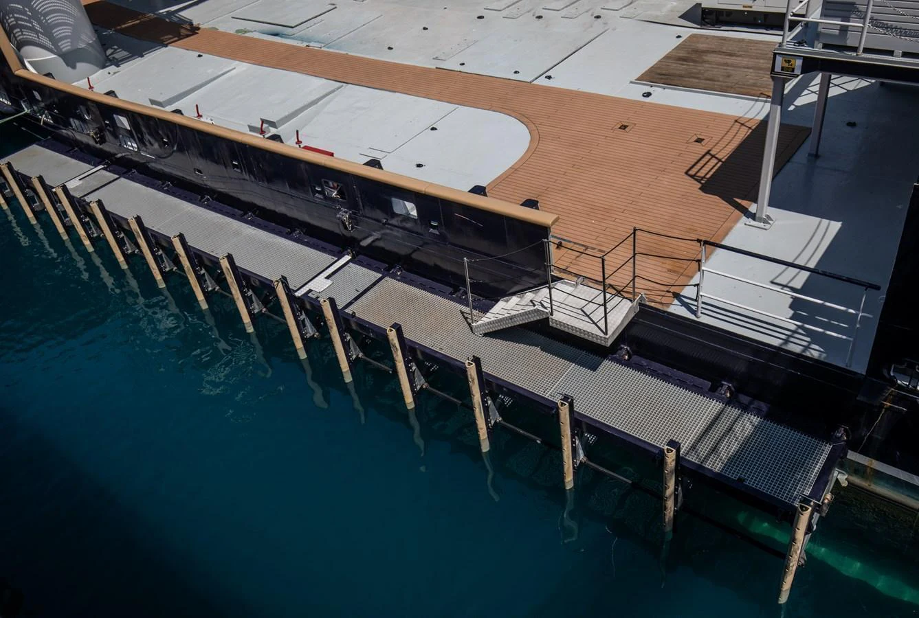 The yacht is docked at a marina, showcasing its sleek deck and modern design. aboard SKY Yacht for Sale