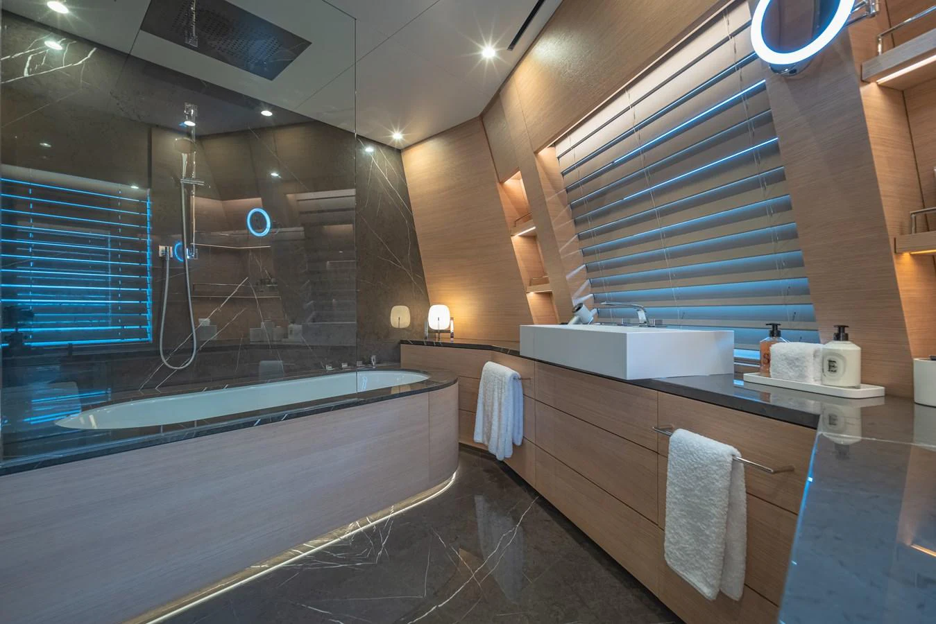 A luxurious yacht bathroom featuring a spacious bathtub, modern fixtures, and elegant lighting. aboard WANDERLUST Yacht for Sale