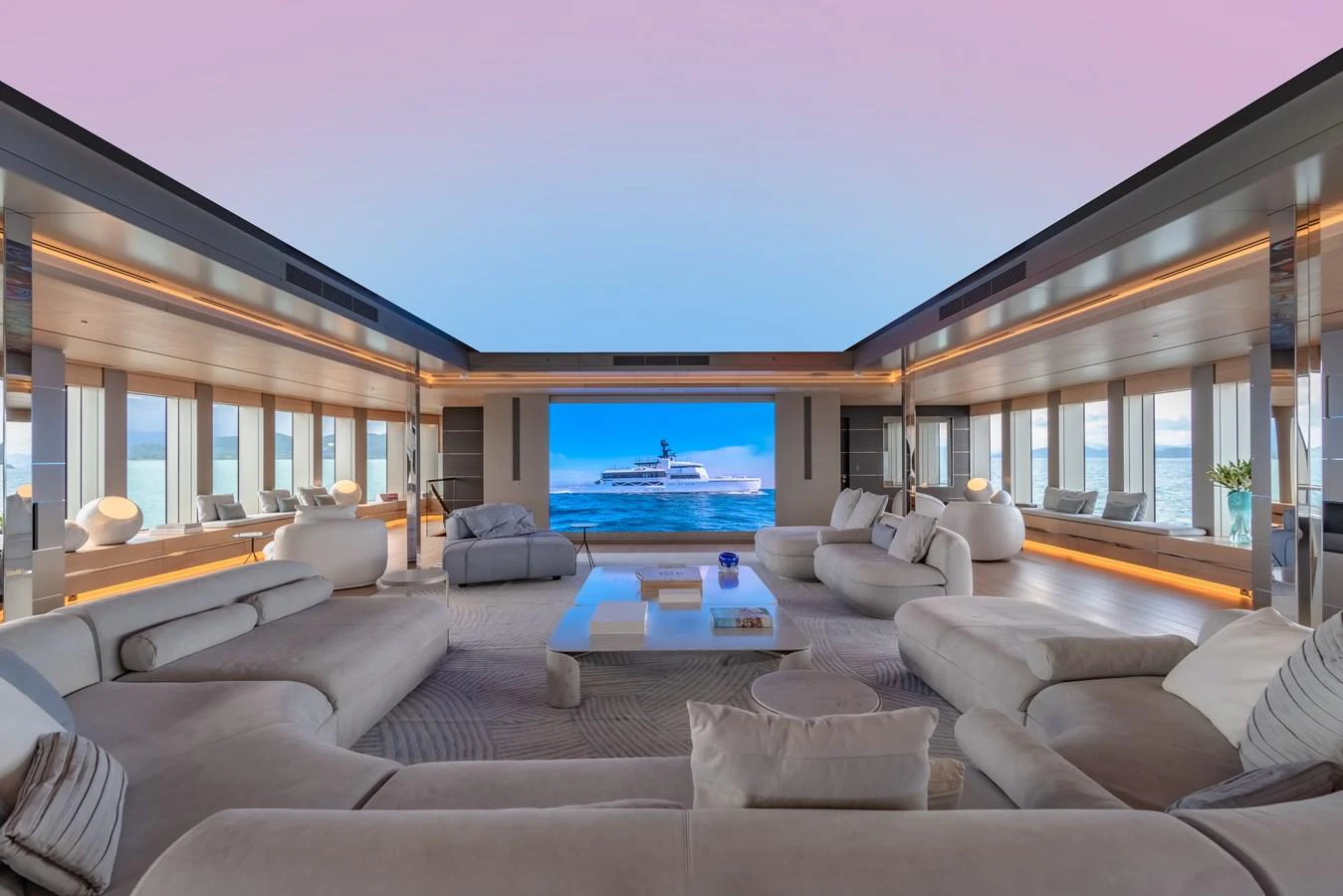 The spacious salon features luxurious seating and a large screen for entertainment, with panoramic windows offering stunning sea views. aboard WANDERLUST Yacht for Sale