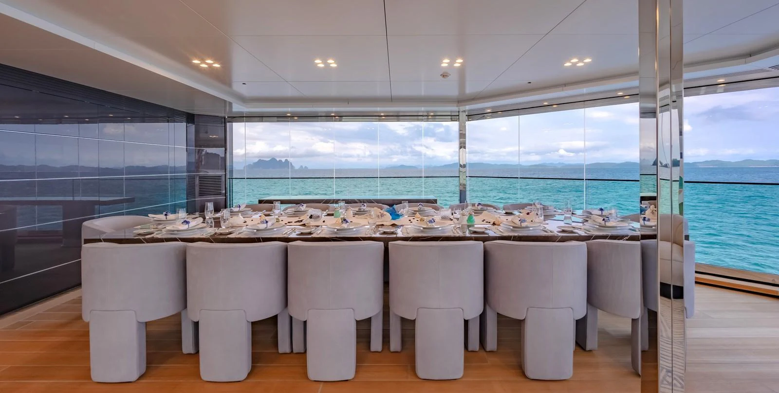 The yacht's dining area offers a luxurious setting with panoramic ocean views and elegant table settings. aboard WANDERLUST Yacht for Sale