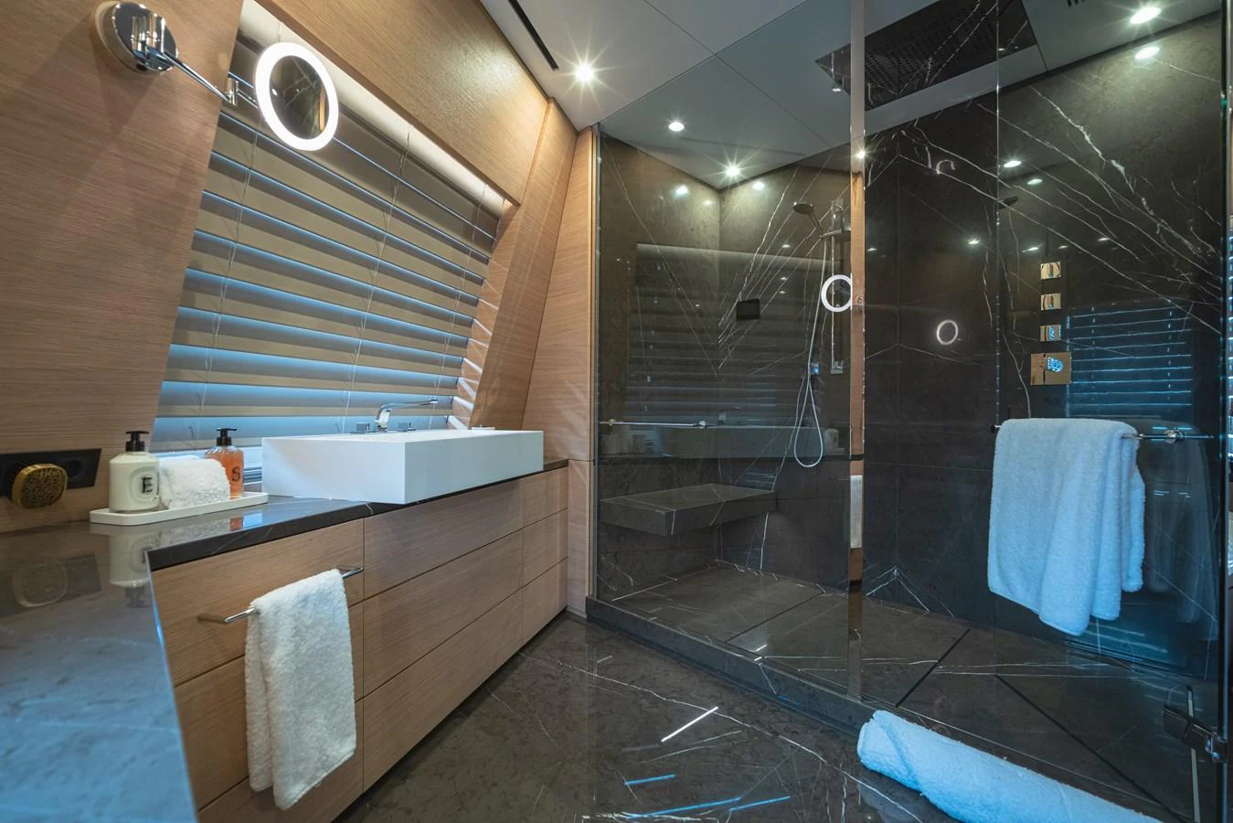 The yacht's bathroom features a modern design with a spacious glass-enclosed shower and sleek fixtures. aboard WANDERLUST Yacht for Sale