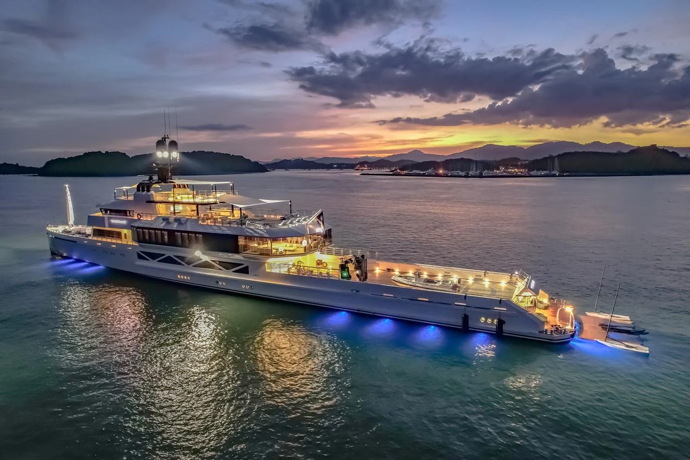 A stunning yacht is illuminated against a picturesque sunset backdrop, showcasing its sleek design and luxurious features. aboard WANDERLUST Yacht for Sale