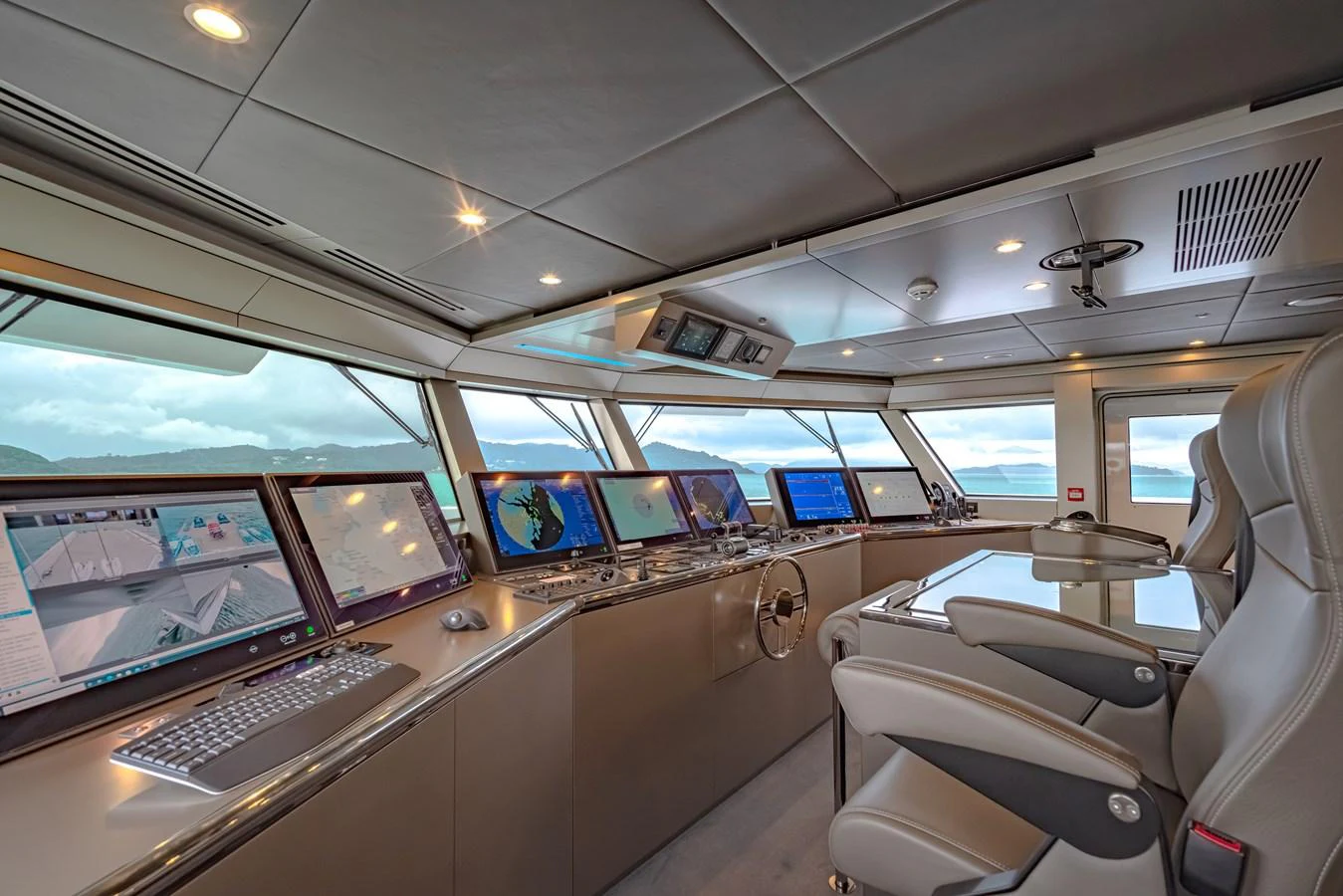 The helm station features advanced navigation equipment and luxurious seating for optimal control and comfort. aboard WANDERLUST Yacht for Sale