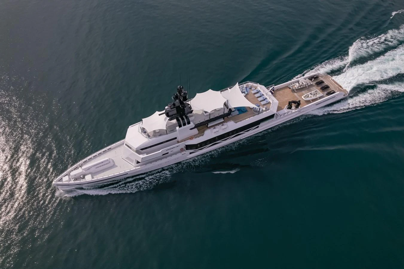 A sleek and modern yacht glides through the water, showcasing its elegant design and spacious deck areas. aboard WANDERLUST Yacht for Sale
