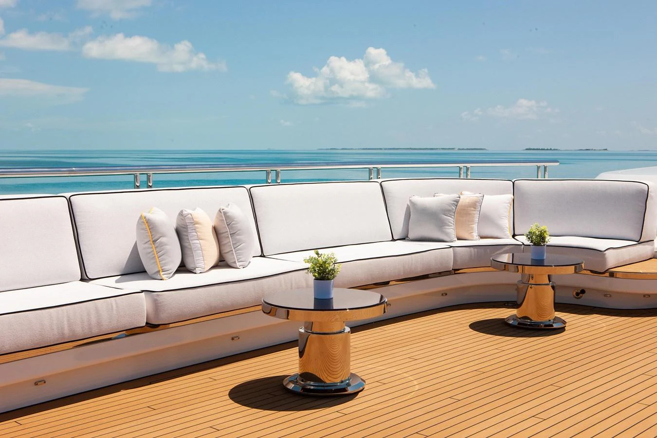 The sundeck features plush seating with elegant tables, offering a perfect spot to relax and enjoy the ocean views. aboard BOARDWALK V Yacht for Sale