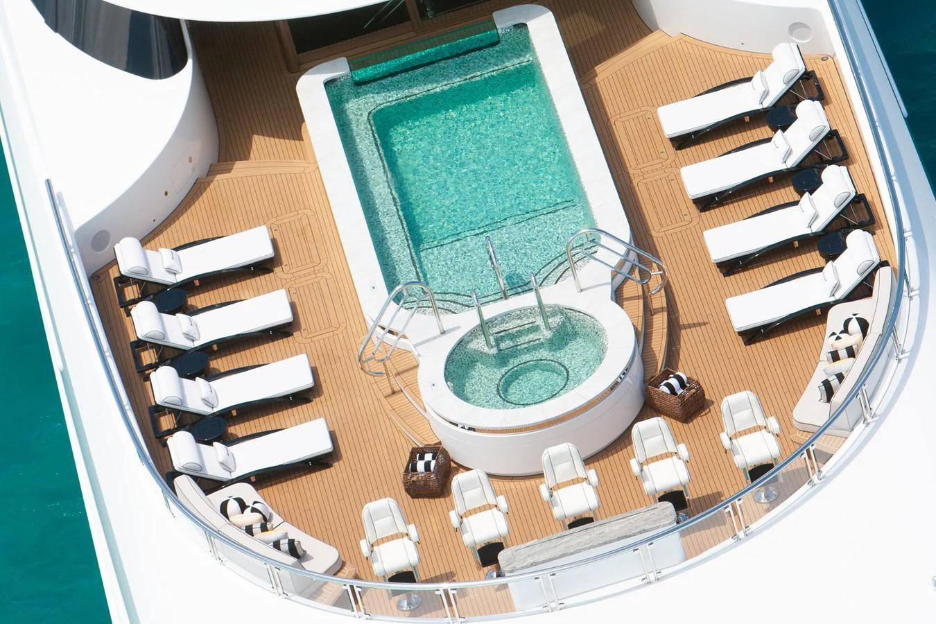 The sundeck features a luxurious pool surrounded by comfortable lounge chairs, perfect for relaxation. aboard BOARDWALK V Yacht for Sale