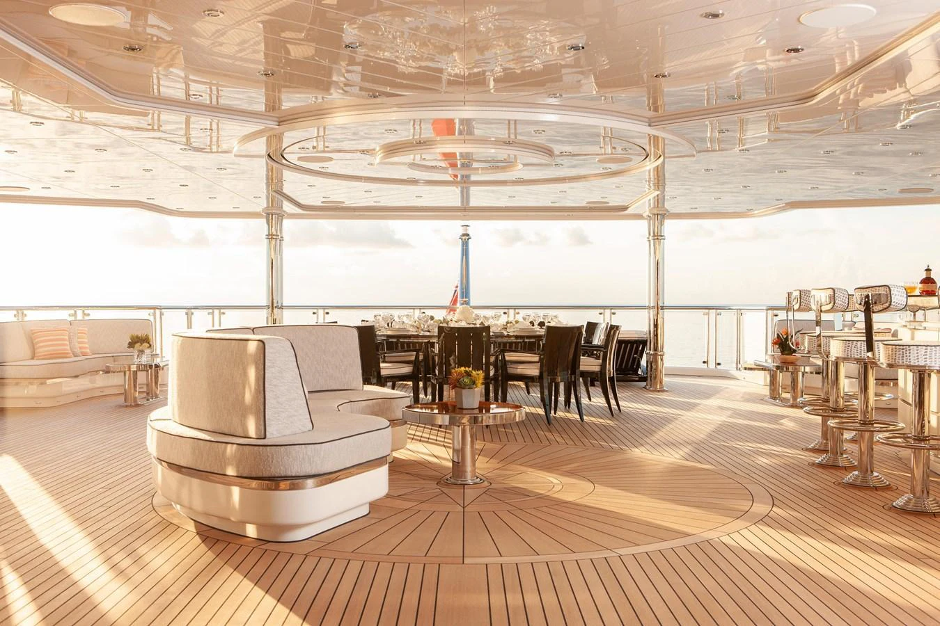 The aft deck offers a luxurious and spacious outdoor dining and lounging area with elegant furnishings and panoramic ocean views. aboard BOARDWALK V Yacht for Sale