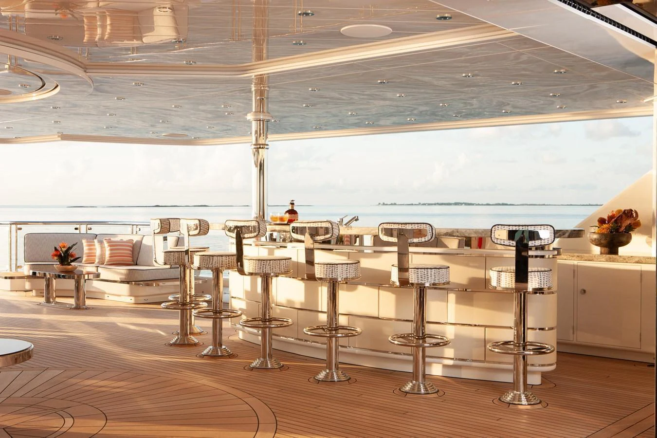 The yacht features a luxurious bar area with stylish seating and a stunning ocean view. aboard BOARDWALK V Yacht for Sale