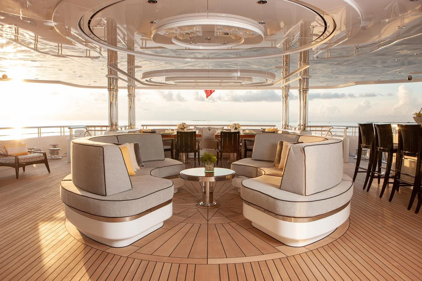 The aft deck features elegant seating arrangements with a stunning view of the horizon. aboard BOARDWALK V Yacht for Sale