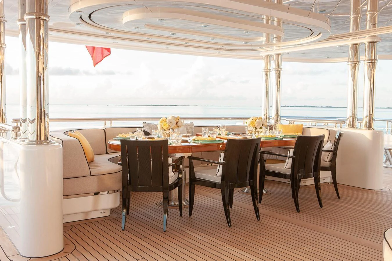 The aft deck offers an elegant dining area with a stunning ocean view. aboard BOARDWALK V Yacht for Sale