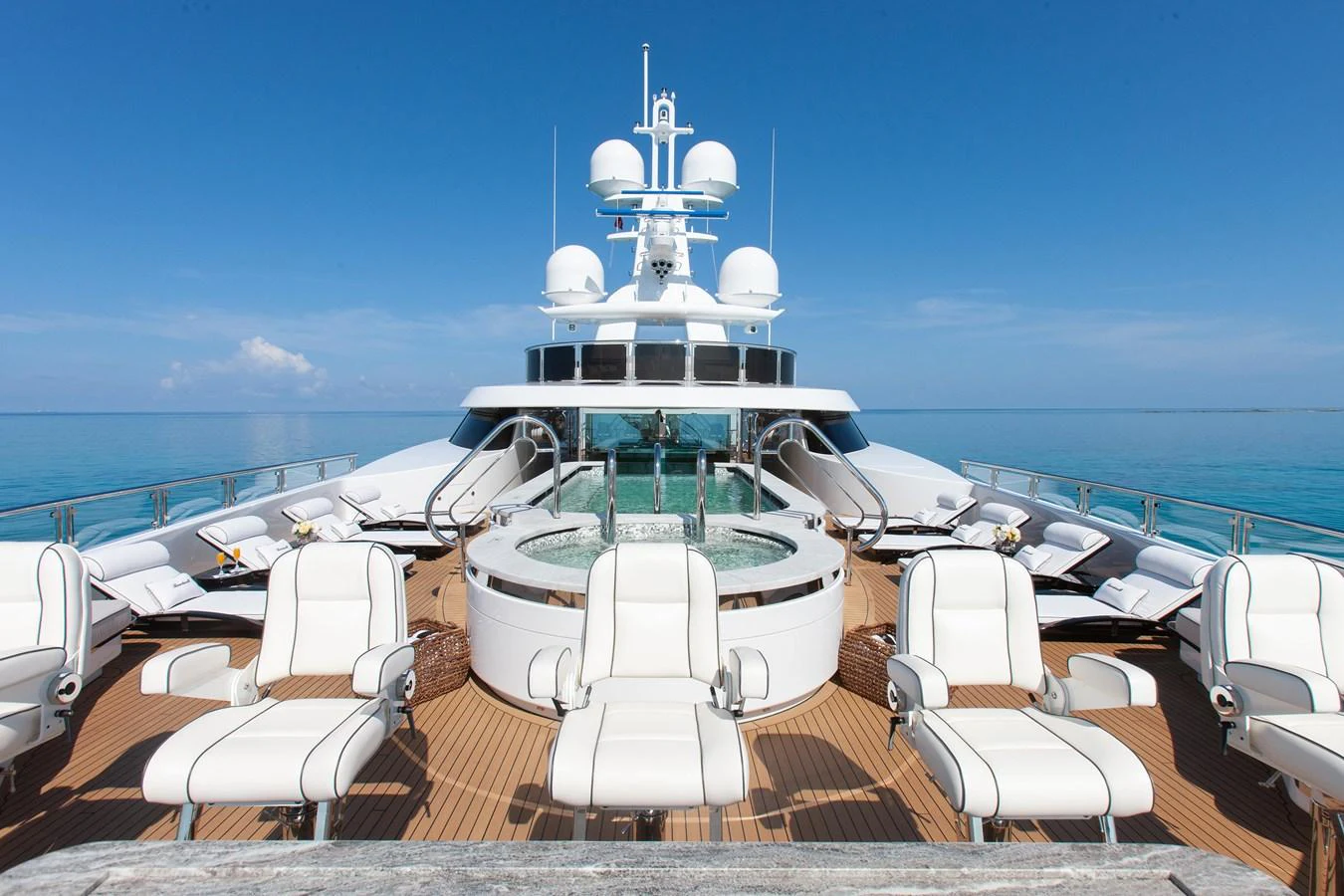 The sundeck features luxurious lounge chairs and a central hot tub with panoramic ocean views. aboard BOARDWALK V Yacht for Sale