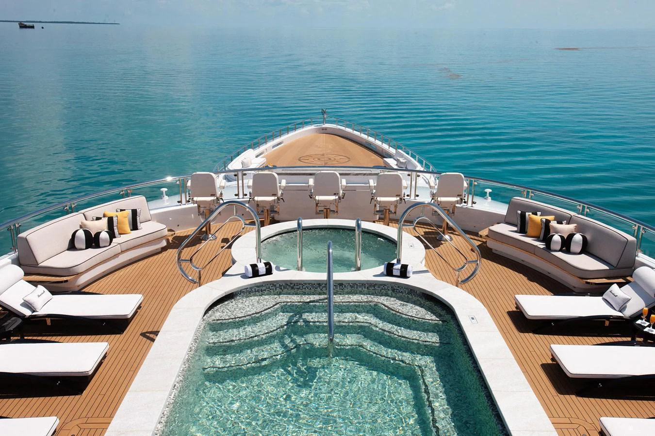 The sundeck features a luxurious pool surrounded by comfortable sun loungers and seating areas, offering stunning views of the open sea. aboard BOARDWALK V Yacht for Sale
