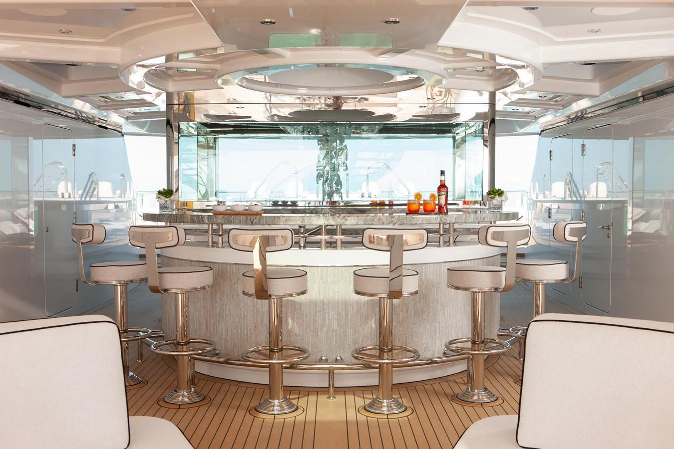 The yacht features a sleek and modern bar area with stylish seating and a polished counter. aboard BOARDWALK V Yacht for Sale