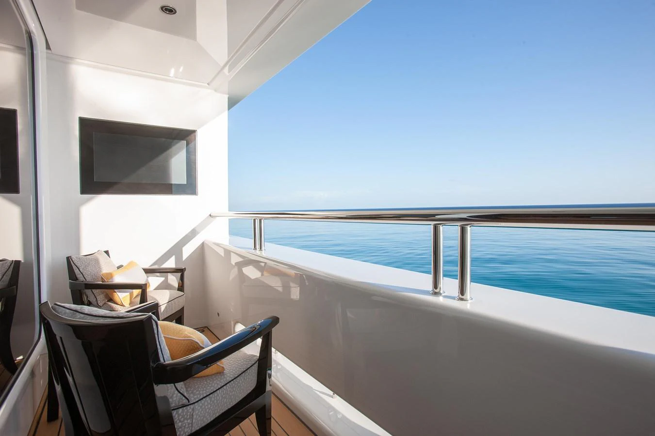 A serene balcony area with comfortable seating and a stunning ocean view. aboard BOARDWALK V Yacht for Sale