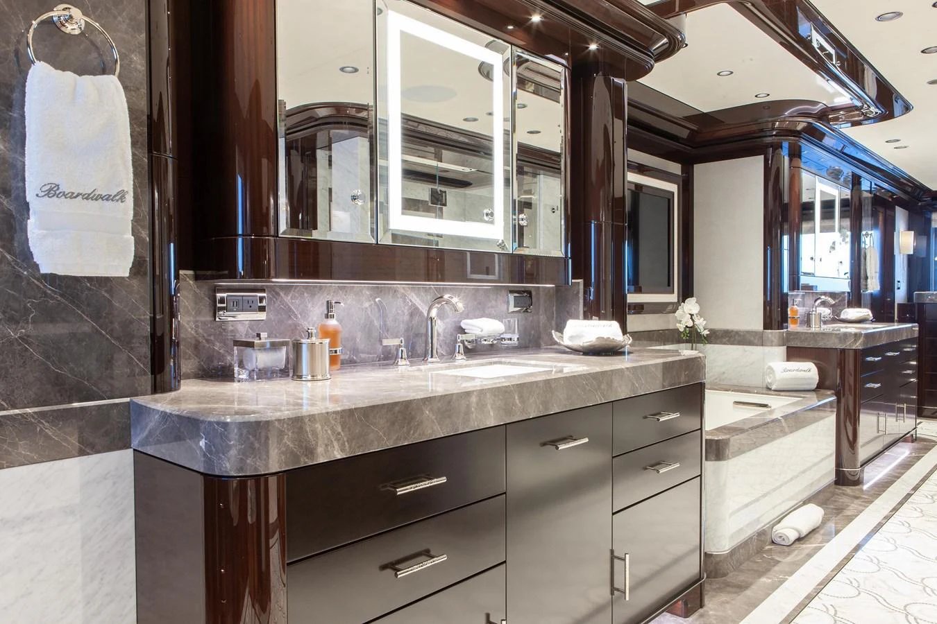 The yacht's bathroom features luxurious marble countertops and sleek cabinetry, creating an elegant and sophisticated space. aboard BOARDWALK V Yacht for Sale