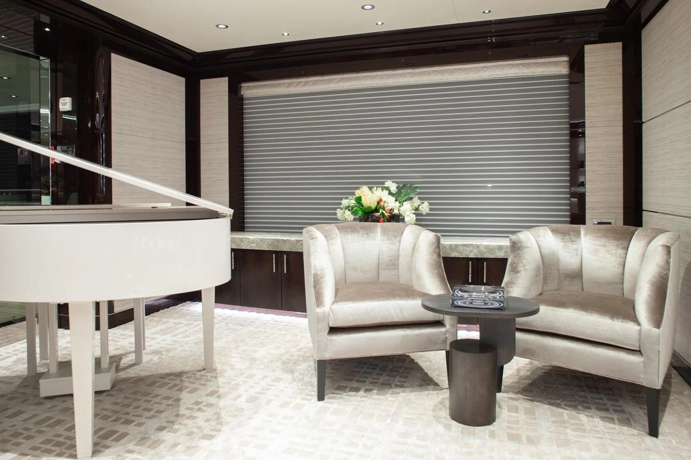 The salon features plush seating and a grand piano, creating an elegant and inviting atmosphere. aboard BOARDWALK V Yacht for Sale