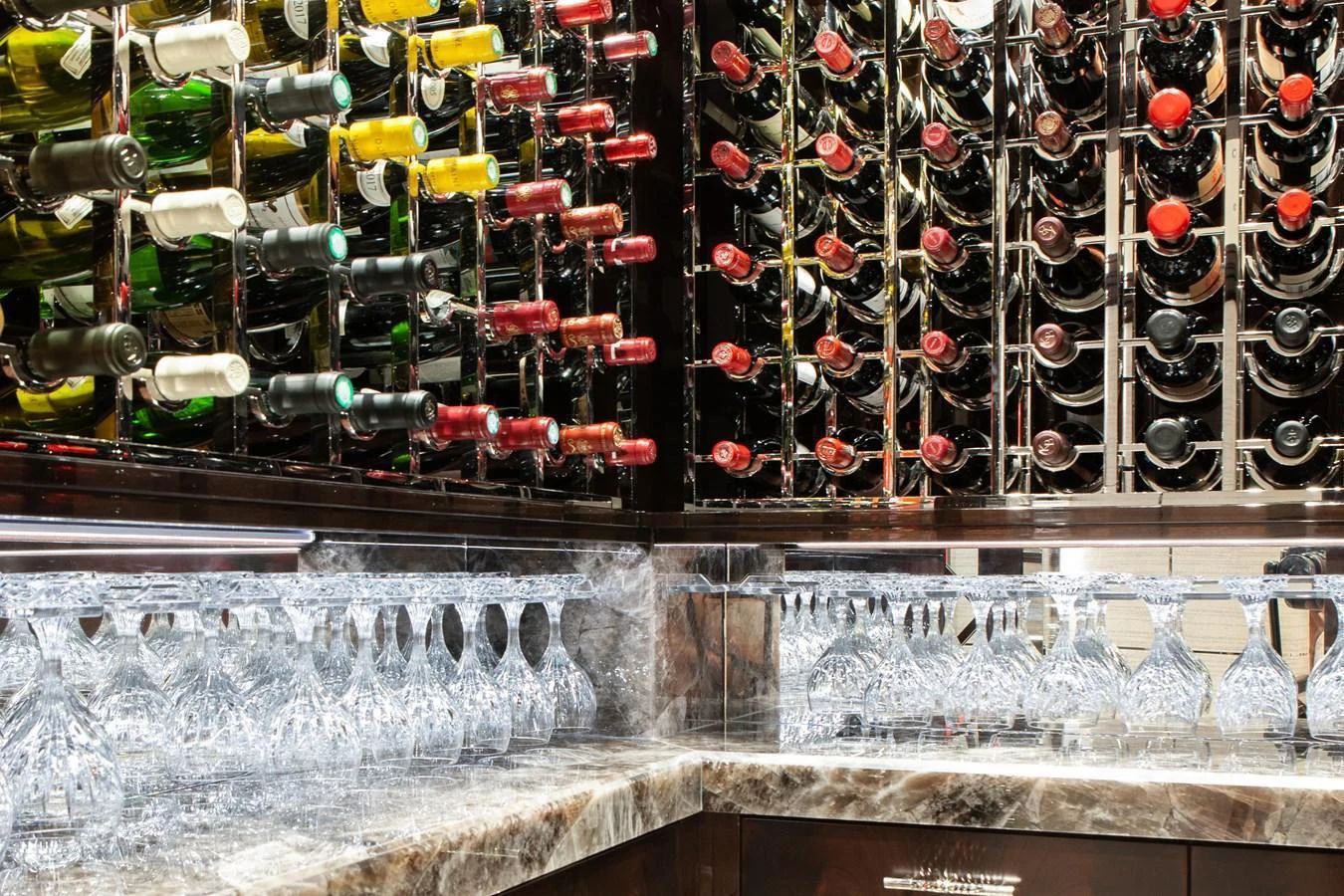 A luxurious wine cellar with an extensive collection of bottles and elegant glassware. aboard BOARDWALK V Yacht for Sale