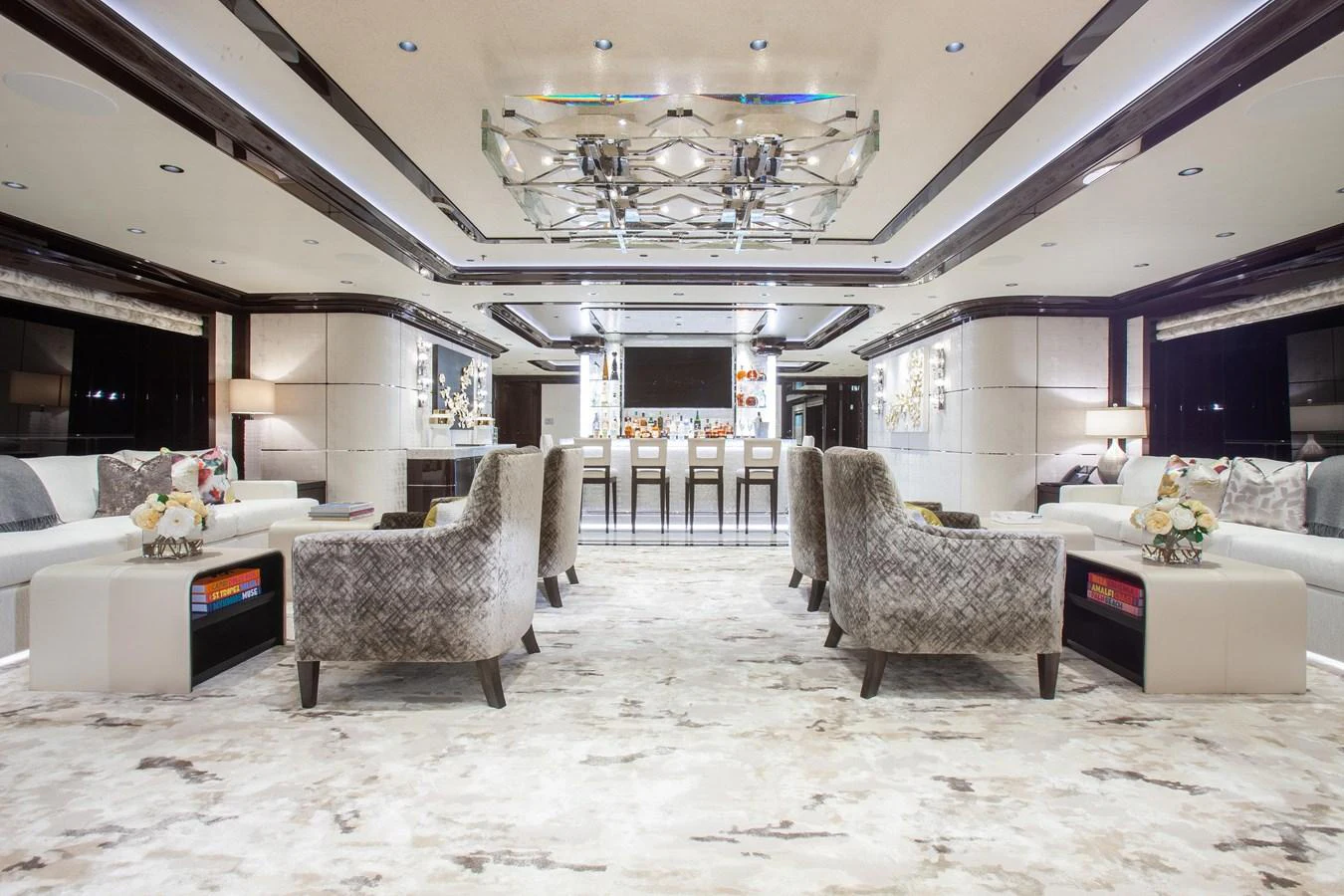 The yacht's salon features luxurious seating and a sophisticated bar area, creating an inviting space for relaxation and entertainment. aboard BOARDWALK V Yacht for Sale