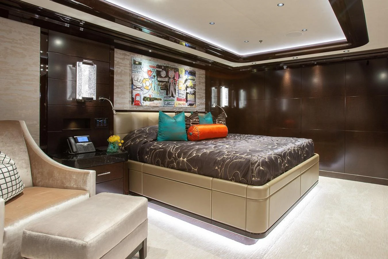 The master stateroom features a luxurious bed with elegant decor and modern lighting. aboard BOARDWALK V Yacht for Sale