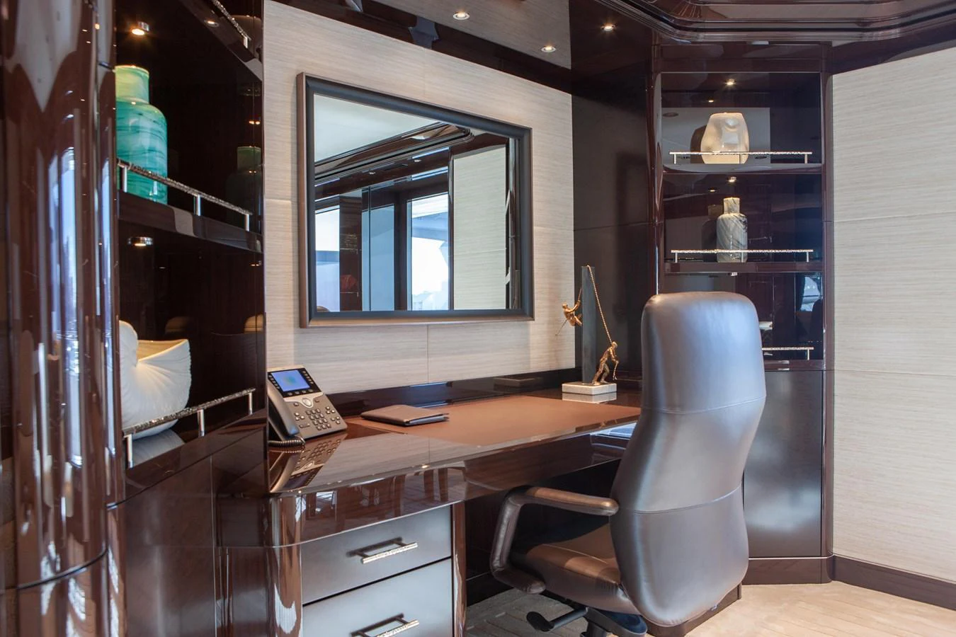 The yacht's office features a sleek desk, comfortable chair, and modern decor, providing a sophisticated workspace at sea. aboard BOARDWALK V Yacht for Sale