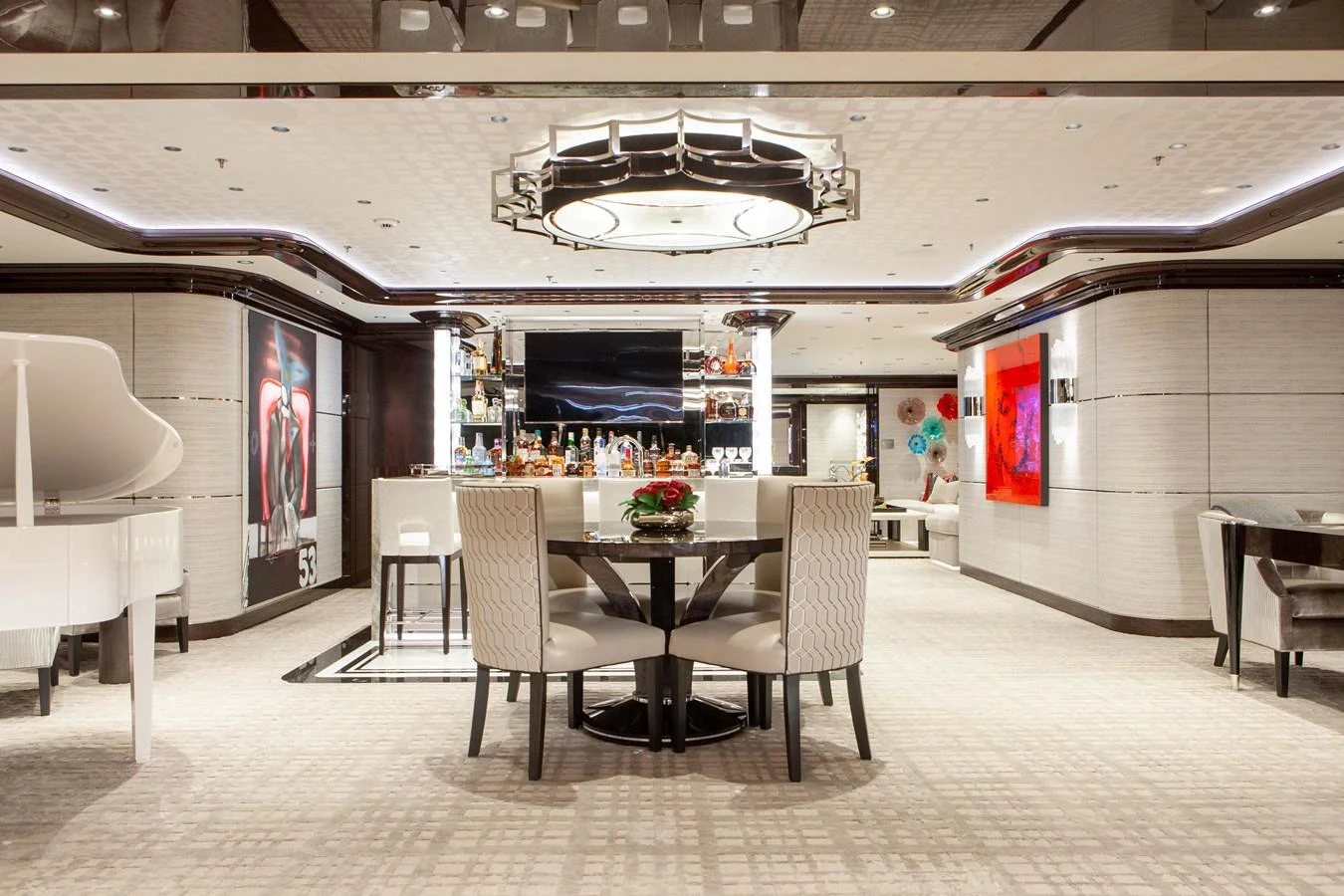 The salon features elegant seating, a grand piano, and a well-stocked bar, creating a luxurious and inviting atmosphere. aboard BOARDWALK V Yacht for Sale